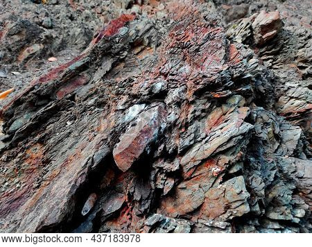 Geodesy. Stone Texture. The Rock Is Brown And Red. Mineral Background. Design From Natural Materials