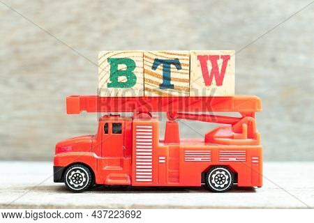 Fire Ladder Truck Hold Letter Block In Word Btw (abbreviation Of By The Way) On Wood Background