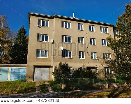 Prague, Czech Republic - October 24, 2021: Old Style Apartment Building With Gray Facade And Garage 