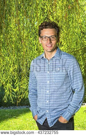 Dressing In A Long Sleeves, Pattern Shirt, Wearing Glasses, Two Hands Putting In Pockets,  A Young H