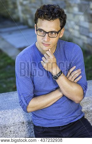 Dressing In A Blue Long Sleeves With Roll-tab Henley Shirt, Wearing Glasses And A Wristwatch, Crossi