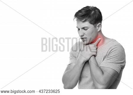 Sad Young European Man Suffer From Sore Throat, Presses Hand To Throat, Monochrome Photo And Highlig