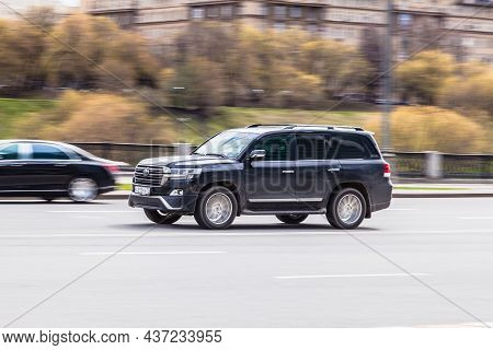 Toyota Land Cruiser 200 Rides On The City Highway. Black Premium Suv On The City Street In Motion. M