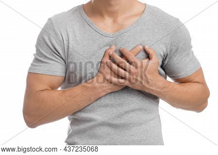 Cropped Millennial European Muscular Male Suffering From Chest Pain, Presses Hand To Sore Spot