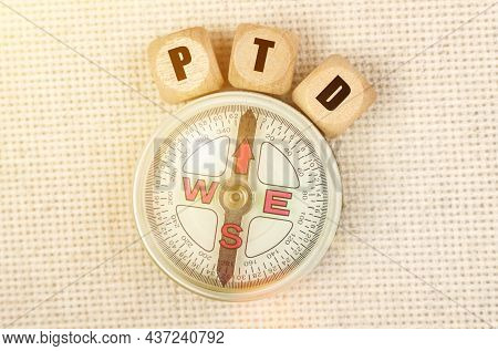 Business Concept. On The Table Is A Compass And Cubes With The Inscription - Ptd