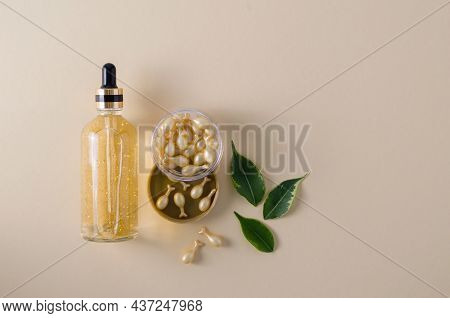 Serum In Glass Bottle And Gel Serum In Capsules In A Transparent Jar For The Care Of The Face, Eyeli