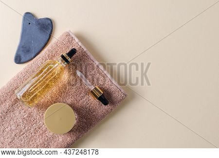 Serum For The Care Of The Skin Of The Face, Eyes, Eyelids In A Glass Bottle On A Brown Towel, Gouach