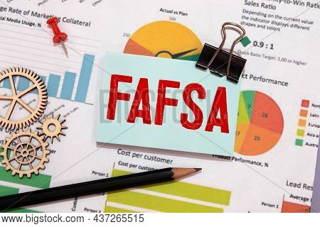 The Word Fafsa In A Notebook On White Table With Office Tools. Business Concept
