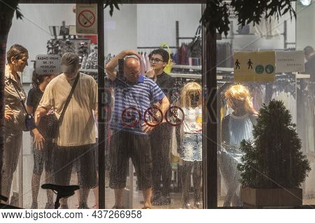 Smederevska Palanka, Serbia - July 18, 2021: Selective Blur On A Crowd Of People Sheltering From Rai