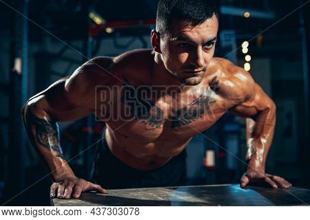 Close-up Young Man, Muscled Athlete, Bodybuilder Push-ups At Sport Gym, Indoors. Concept Of Sport, A