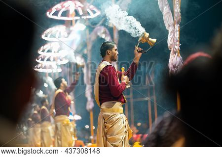 17.12.2019, Varanasi, India. Sacred Religious Ceremony Arati In The Temple. A Group Of People Burn I