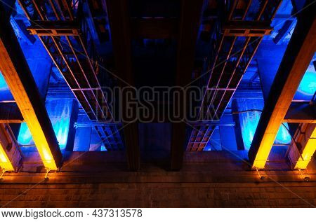 Communal Bridge Under Blue And Golden Lights. Illumination Underbridge Space At Night. Abstract Indu