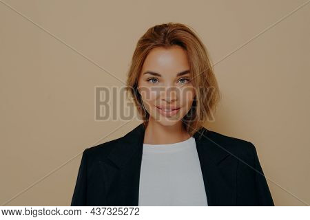 Close Up Portrait Of Confident Smiling Business Woman In Formal Black Blazer Worn Over White Blouse,