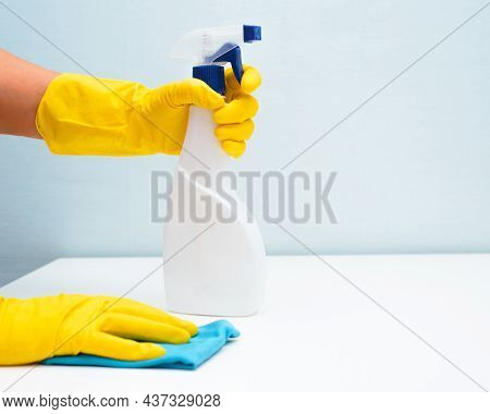House Cleaning, Housework Concept. Close-up Of Hand In Yellow Glove With Rag And Antibacterial Chemi