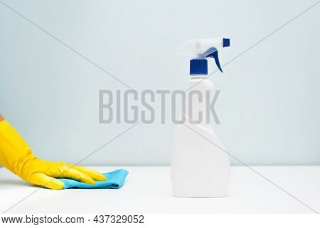 Close-up Of Hand In Glove With Rag And Antibacterial Spray On Table, Housewife Wiping White Clean Su
