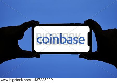 Tashkent, Uzbekistan - 22 October, 2021: Hands Hold Smartphone With Coinbase Logo. Close-up Of Mobil