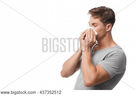 Millennial Attractive Caucasian Guy Suffering From First Symptoms Of Flu And Cold, Runny Nose, Blows