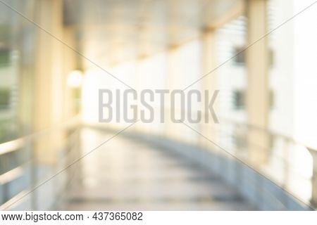 Abstract Blur Walkway Corridor. Blurred Hall Interior In Public Building. Defocused Bokeh Effect Bac