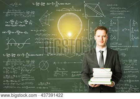 Attractive Young European Businessman Holding Books With Abstract Lamp Sketch With Mathematical Form