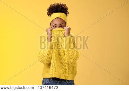 Charming Cute Silly Young African-american Modern Girl Pulling Sweater On Face Hiding Peeking Camera