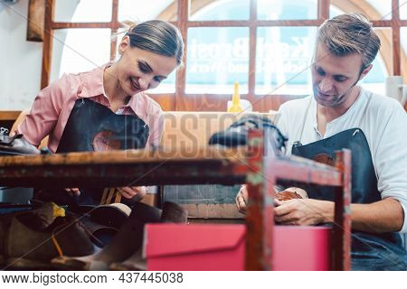 Woman and man shoemaker working together