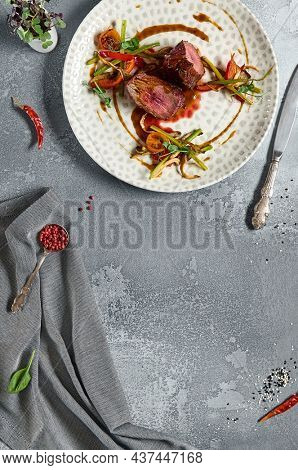 Roasted Beef fillet with vegetables. Roasted Mignon steak with paprika and celery. Beef tenderloin with garnish. Beef steak medium rare doneness. Delicious meat menu. Dish concept with angus beef