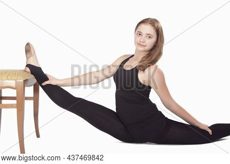 Sport Concepts. Caucasian Sportswoman Rhythmic Gymnast In Training Outfit During Legs Muscles Stretc