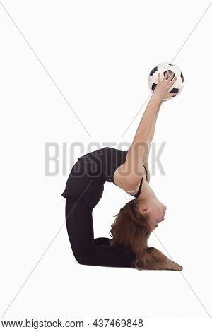 Young Caucasian Gymnast Sportswoman In Training Outfit During Legs Split Exercises Muscles Stretchin