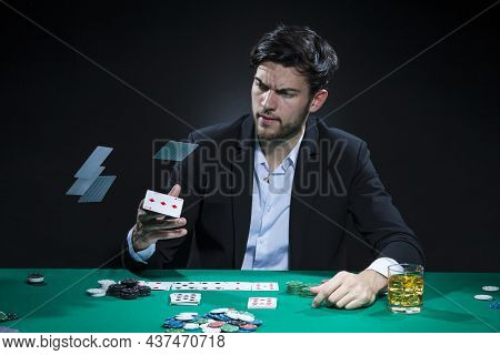 Casino Ideas And Concepts. Handsome Caucasian Young Pocker Player Staking And Betting To Win At Pock