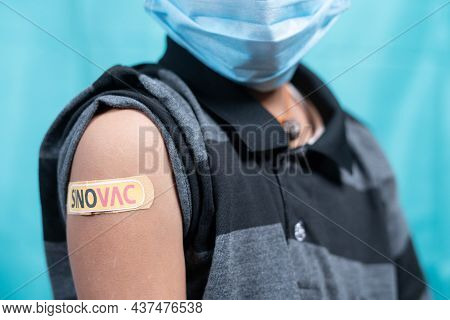 Maski, India - October 26, 2021 : Kid With Medical Face Mask Showing Sinovac Vaccine Bandage On Shou