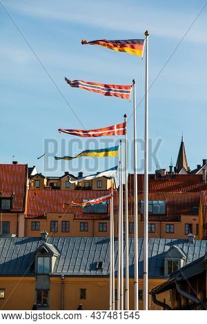 Visby, Gotland, Sweden - Oct 1, 2021: Flags Of Different Countries And Roofs Of The Old Ancient City