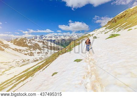 Swiss Man Walking In The Snow On Iced Trail Of Muottas Muragl In Switzerland. Popular Mountain Excur