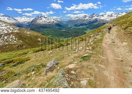Swiss People Trekking In On The Mountain Trail Of Muottas Muragl In Switzerland. Popular Mountain Ex