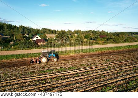 Tractor On Cultivating Field Work. Soil Tillage In Farmers Country. Agricultural Tractor On Cultivat