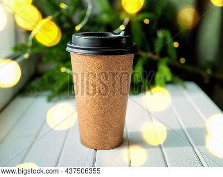 Paper Cup Of Coffee Witr Muffin, Pine Cone And Mandarin Surrounded By Christmas Decorations On Chris
