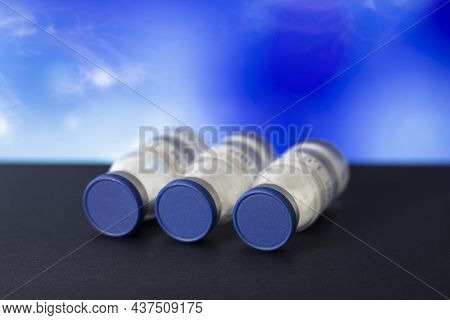 Vaccine Bottles On A Blue Background. Medicine.