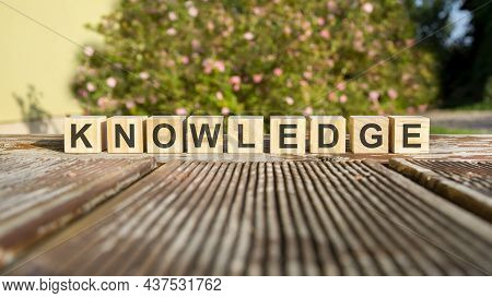 The Word Knowledge Written On The Cubes In Black Letters