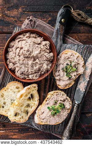 Toasts With Duck Pate Rillettes De Canard On Wooden Board. Dark Wooden Background. Top View
