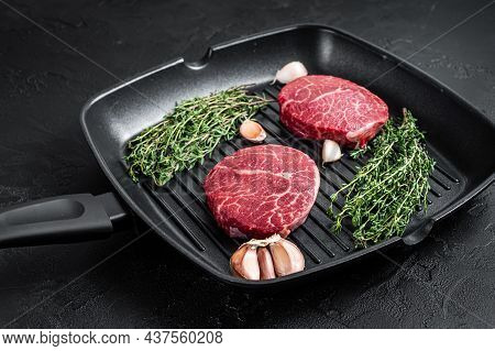 Tenderloin Raw Fillet Mignon Beef Steaks On A Pan. Black Background. Top View