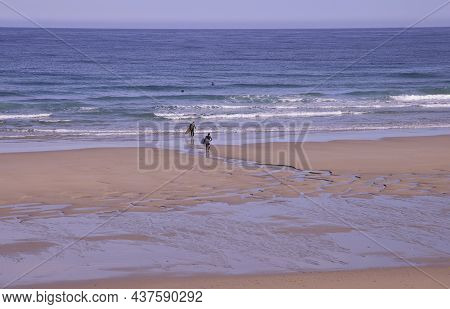 Coto Beach (lugo, Spain), October 23, 2021. Surfers On A Beach Of The Cantabrian Sea. It Is An Area 