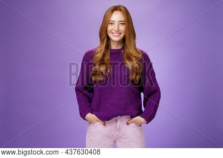 Optimistic Attractive Ginger Girl In 20s Wearing Purple Sweater Standing Ready And Energized Over Vi