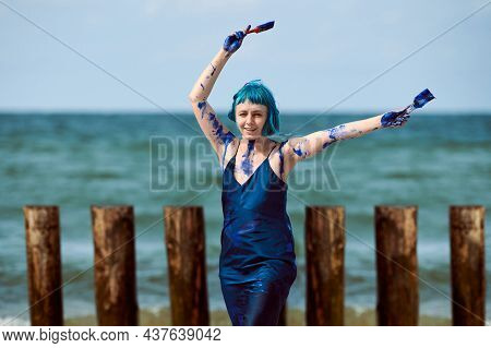 Artistic Blue-haired Woman Performance Artist In Dark Blue Dress Smeared With Blue Gouache Paints Pa