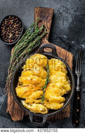 Potato Gratin Dauphinois In A Pan. Black Background. Top View