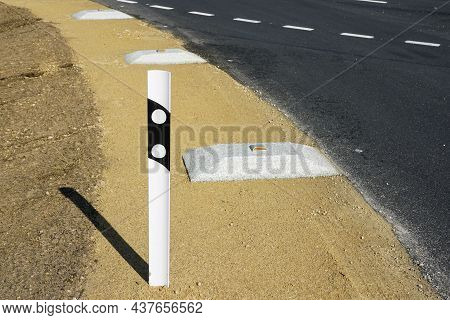 Reconstructed Road Edge With Plastic Road Post With Reflector And Concrete Speed Bump With A Reflect