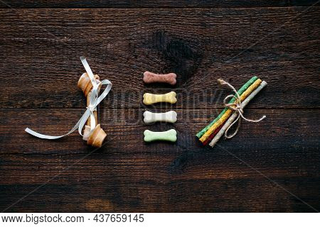 Dog Bone In Bowl On Wooden Background. Artificial Bones And Mini Tiny Treats For Pets. Long Lasting 