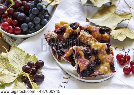 Traditional Italian Yeast Dough Pie With Grapes Schiacciata And Bunches Of Grapes On A Light Backgro