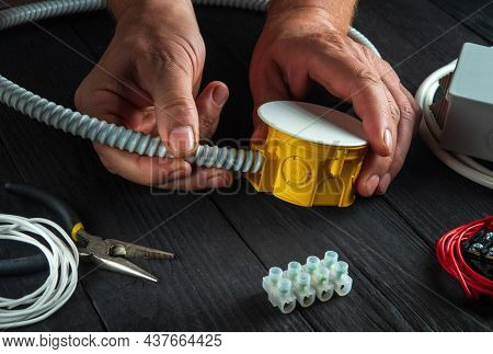 Installing Cable Or Wire To A Junction Box. Electrical Connection In The Workshop Of Professional Ma