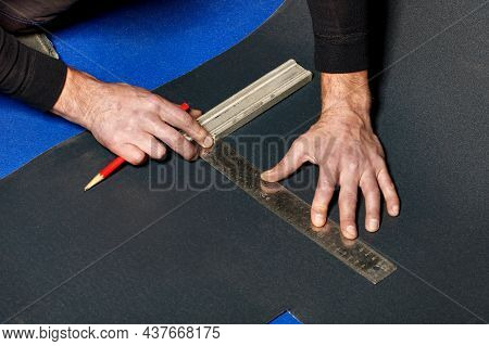 The Male Hands Of A Worker Marks Out A Sheet Of Roofing Iron With A Pencil And A Ruler For Subsequen