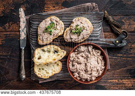 Toasts With Duck Pate Rillettes De Canard On Wooden Board. Dark Wooden Background. Top View