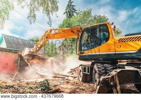 Building Demolition. Excavator Breaks House. Space For Construction New Building.